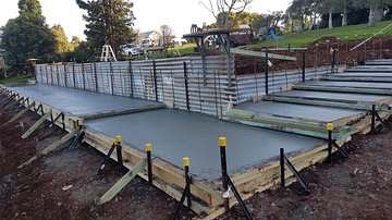 Steel roof trusses erected over a new slab