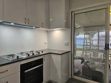 Renovated kitchen with stone-look benchtop and splashback