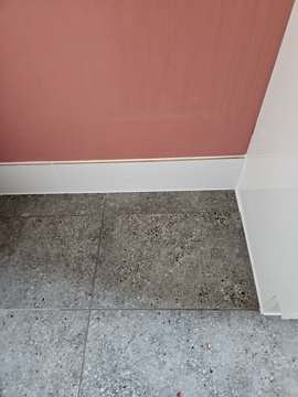New bathroom floor tiles laid up to skirting