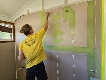 Waterproofing membrane rolled up the wall over taped junctions
