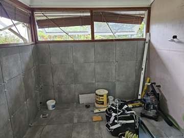 Wall and floor tiles going on over the sealed substrate